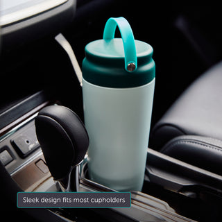 Teal Elvie breast milk cooler with teal lid and handle in a car cupholder