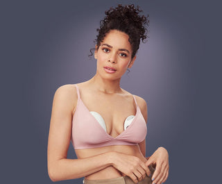 Woman wearing a pink bra with Elvie Curve inserted