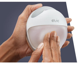 Hand holding a white Elvie Curve pressing the silicone insert