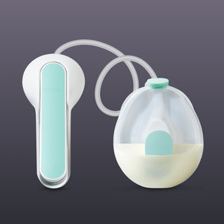 White and light blue manual breast pump on a dark background