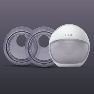 An Elvie Catch and Elvie Curve arranged on a dark grey gradient background. The word 'elvie' is visible on the Curve pump head and faintly on the Catch.