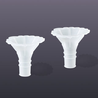Two white Elvie wave silicone inserts on a dark grey background