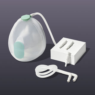 Elvie Wave manual breast pump collection cup with white tubing components on a dark background