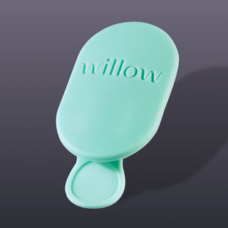 Mint green Elvie Wave valve on a dark grey background